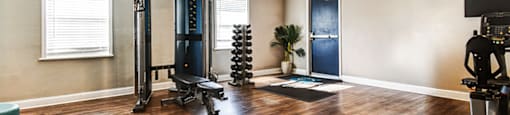 Fitness center at Ashton Brook Apartments, featuring strength equipment.