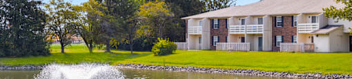 Scenic view of the pond at Fairington Apartments in Anderson, surrounded by greenery.