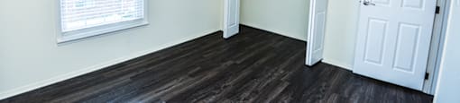 Bedroom with a window and closet in a townhome at Carriage House Evansville.