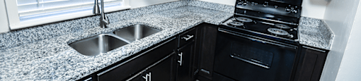 Kitchen in a townhome with cabinets and granite countertops at Carriage House Evansville.
