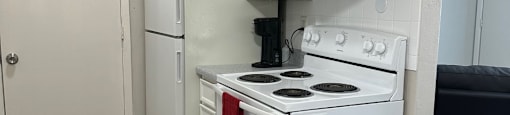 a kitchen with white appliances and a refrigerator and a stove at shiloh commons belleville