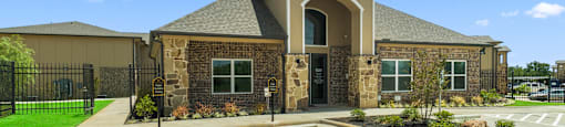 the exterior of a building with a parking lot and a driveway