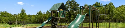 a playground with two slides and a jungle gym