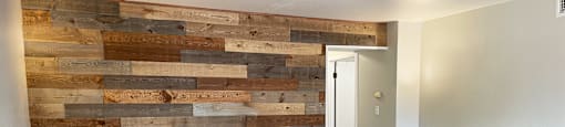 living room with wood accent wall at Shiloh Commons Apartments