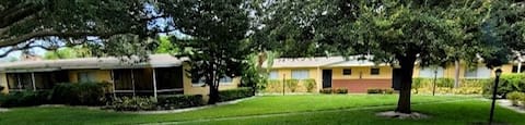professional landscaping with mature trees and neat lawn