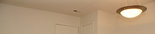 The entrance to the apartment has linoleum flooring and then wall to wall carpet. There is a coat closet just off the entry and overhead lighting in the dining room.