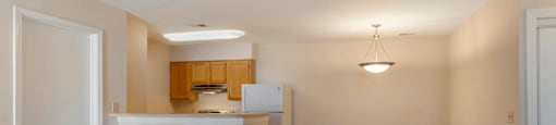 Carpeted Living Room Connected to Breakfast Bar off of Kitchen