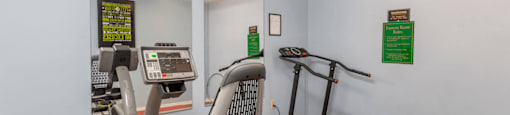 Fitness Center with Exercise Equipment and Mirror Accents on Wall