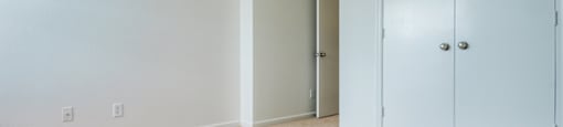 The bedroom has wall to wall carpet and double doors leading to closet.