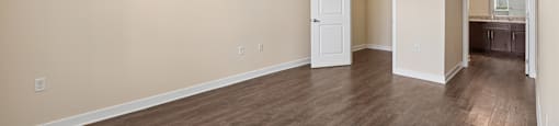 A room with a wood floor and a ceiling fan.