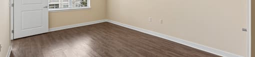 Empty room with a ceiling fan and a window.
