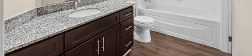 A bathroom with a sink, toilet, and bathtub.