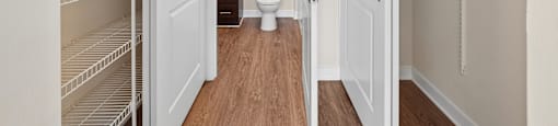 A white pantry with a toilet in the middle.