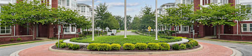 A roundabout with flags in front of a building.