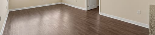 A room with a wooden floor and a ceiling fan.