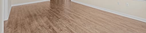 A room with wooden floors and white walls.