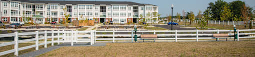 A white fence in front of a building.