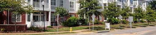A street view of a residential area with apartment buildings.