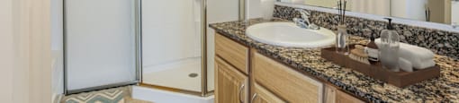 a bathroom with a sink and a shower at Stone Gate Apartments in NC