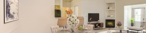 a dining room with a table and chairs and a living room at Stone Gate Apartments, Spring Lake, NC