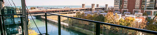 a balcony with a view of a river and a city in the background