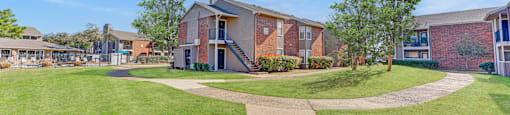 Courtyard with walking paths and landscaped lawns at Towne Centre Village Apartments, Mesquite, 75150