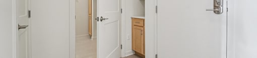 A white door is open to a hallway.
