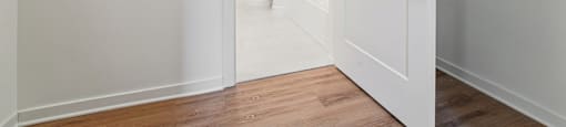 A white door is open to a hallway.