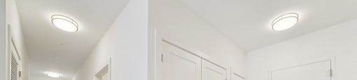 A hallway with white doors and a light blue door at the end.