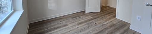 A room with a wooden floor and white walls.