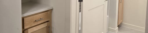 A white door is open to a hallway.