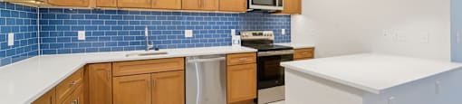 A kitchen with wooden cabinets and a white countertop.