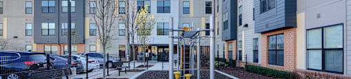 A modern courtyard surrounded by apartment buildings.