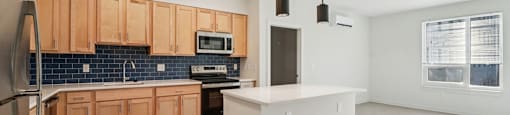 A kitchen with wooden cabinets and a white island.