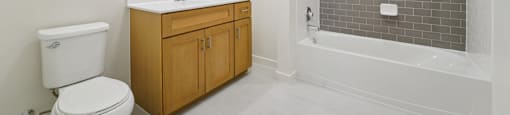 A white toilet sits next to a sink in a bathroom.