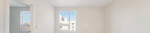 Empty room with a window and a door.