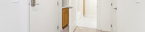 A white door with a silver handle is on the left side of the image.