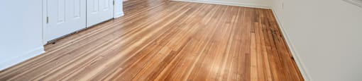 A room with wooden floors and white walls.