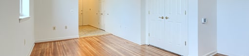 A room with wooden floors and white walls.