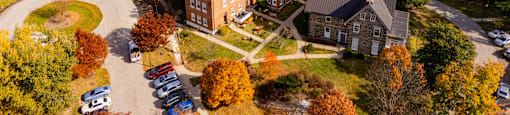 An aerial view of a campus with a large building in the center.