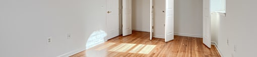 A room with wooden floors and white walls.