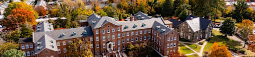 A large building with a circular driveway in front of it.