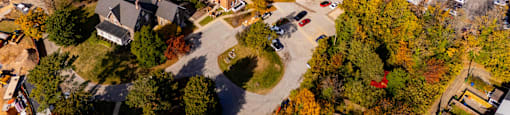 An aerial view of a campus with a large building in the center.