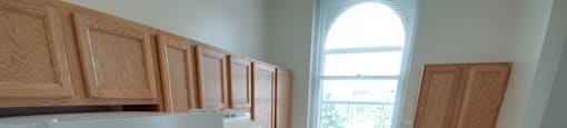 A kitchen with wooden cabinets and a white fridge.