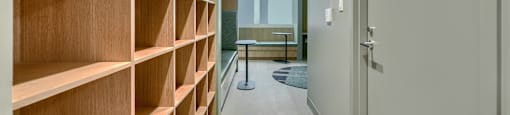 A long hallway with a bench and a door.