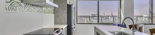 A modern kitchen with a view of the city.