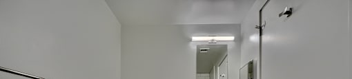 A white bathroom with a toilet, sink, and cabinet.