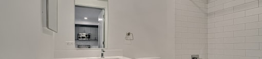 A white bathroom with a toilet, sink, and bathtub.