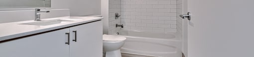 A white bathroom with a walk in shower.