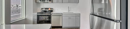 A modern kitchen with a refrigerator on the right.